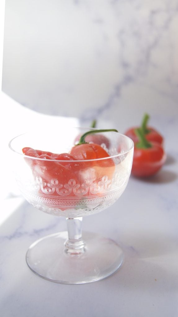 two habaneros in a decorative glass.