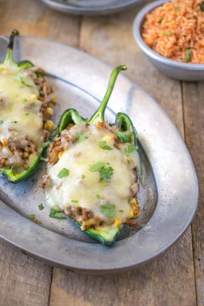 two stuffed peppers on a metal tray.