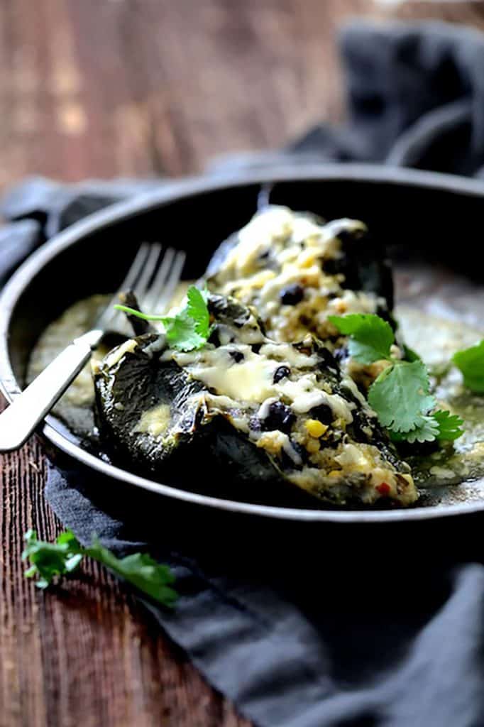 dark moody photo of stuffed peppers on a plate.