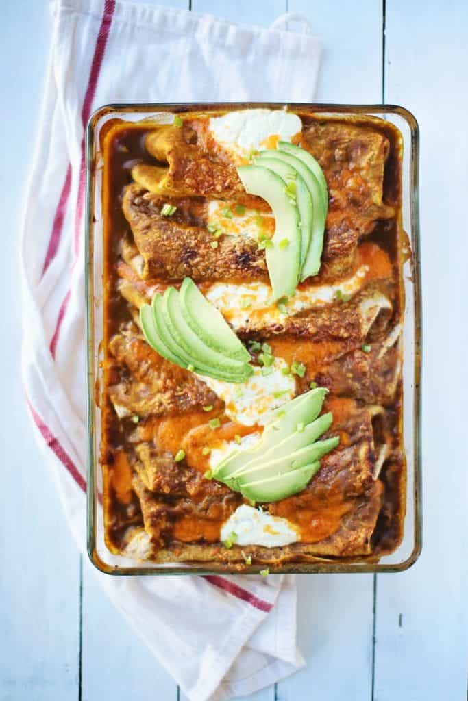 glass baking dish filled with enchiladas.