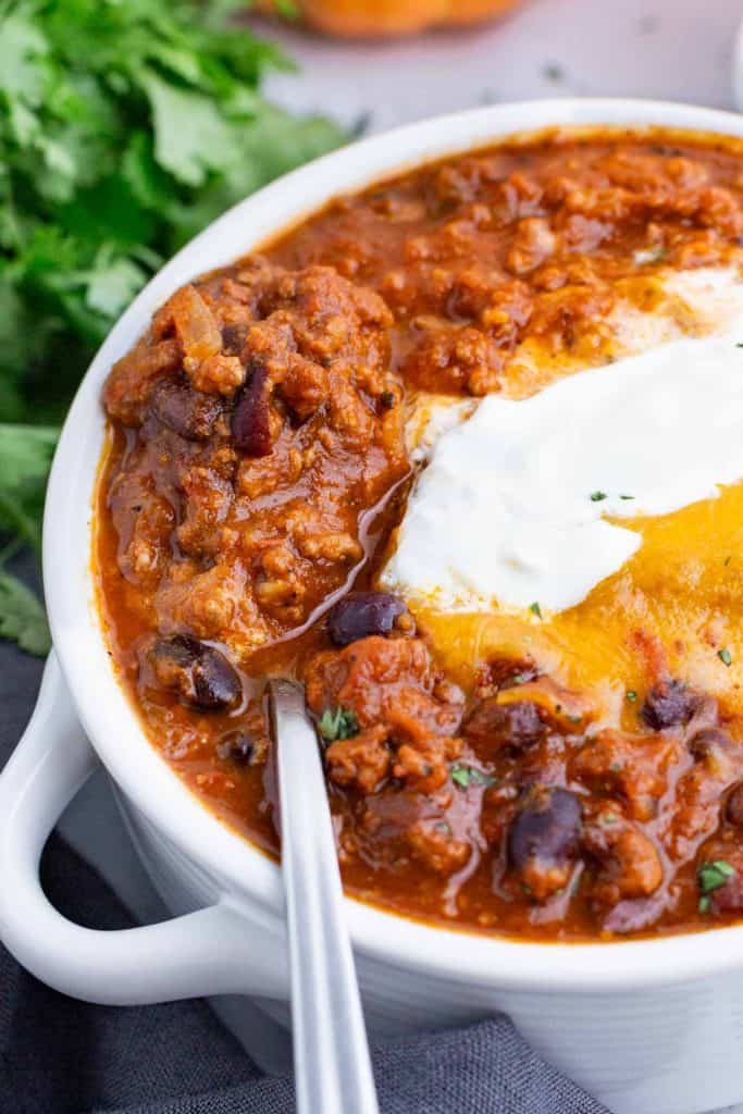 chili topped with cheese and cream.