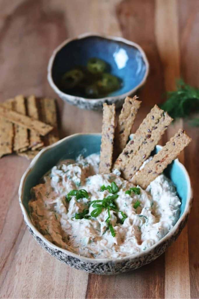 bowl of tuna dip with tall crackers.