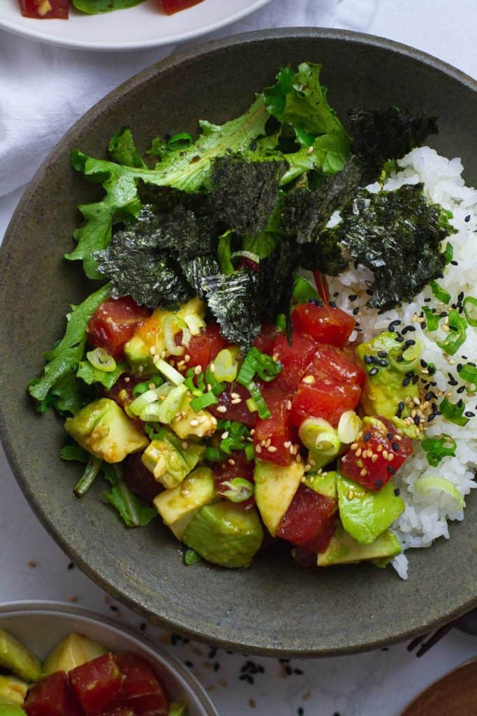 bowl of tuna poke with seaweed and avocado.