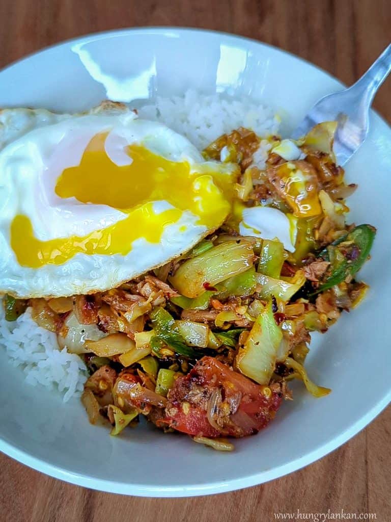 tuna cabbage stir fry with a runny fried egg.