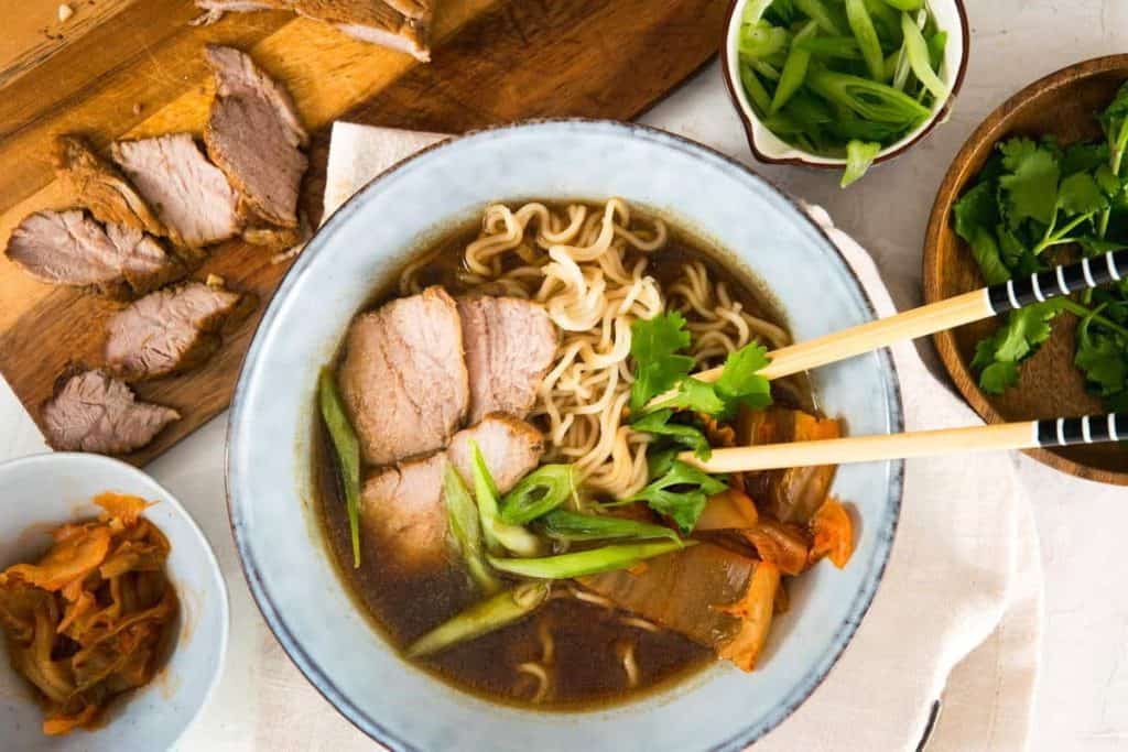 bowl of ramen with kimchi and pork.