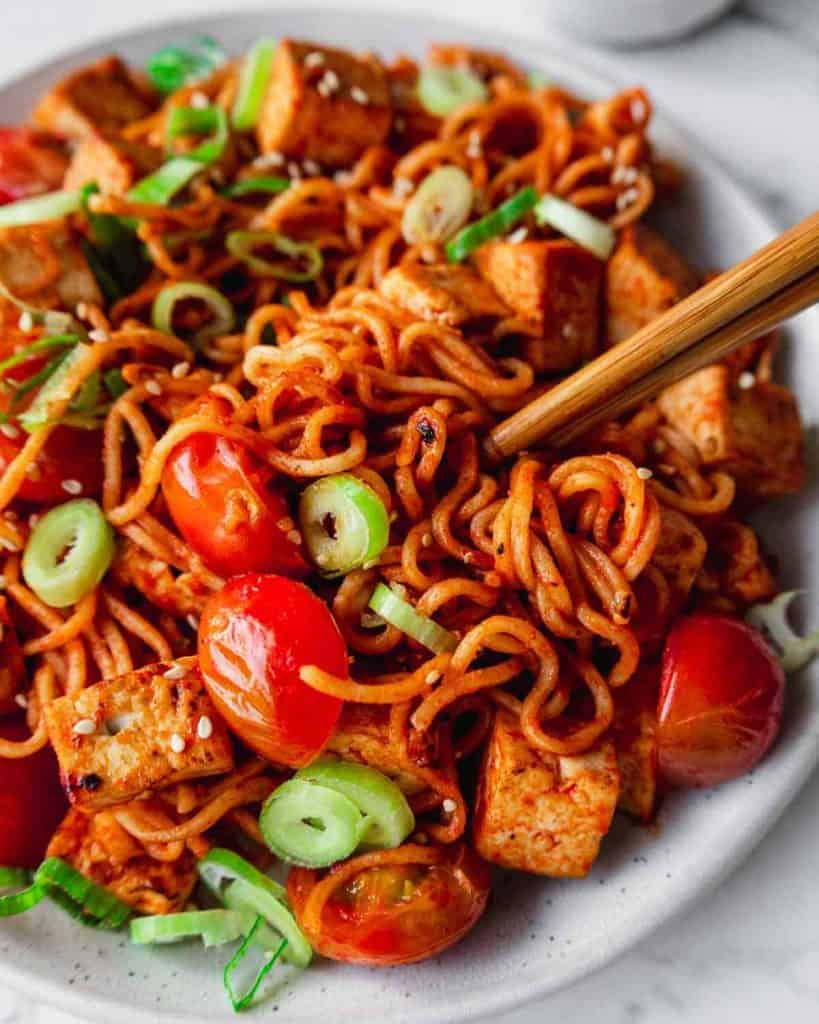 dry ramen noodles with tofu and tomato.