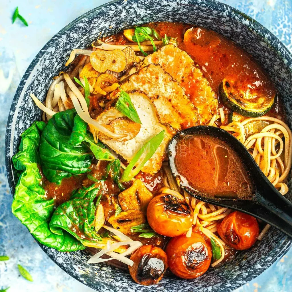 bowl of spicy ramen with soup spoon.