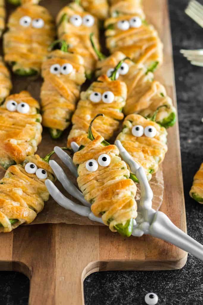 jalapeno poppers wrapped in crescent roll with candy eyes to resemble mummies.