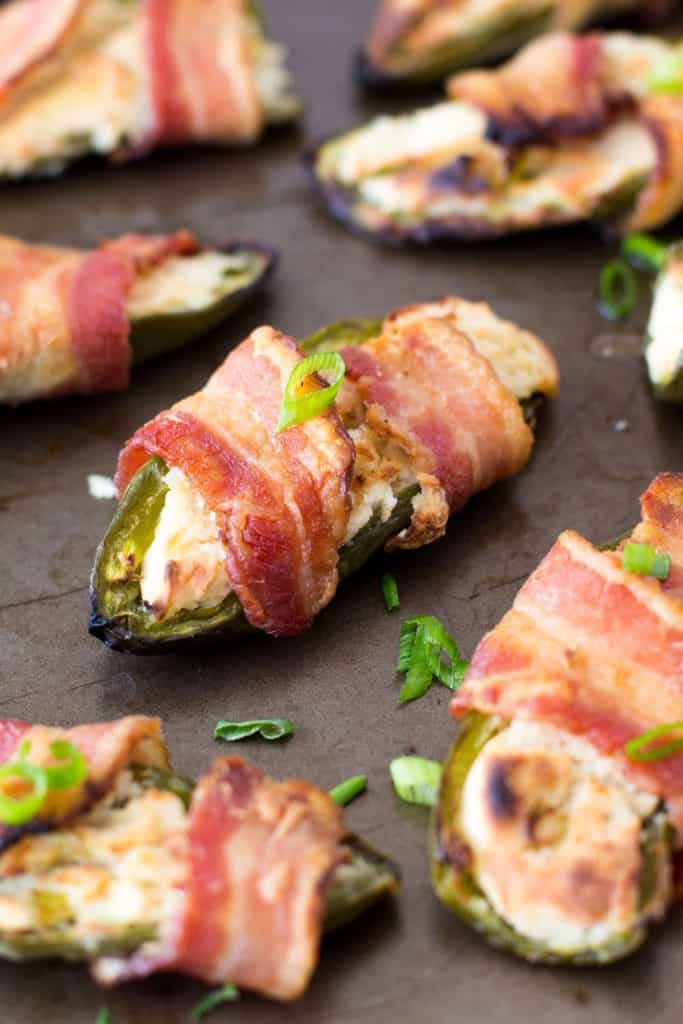 bacon wrapped jalapeño poppers with green onions.