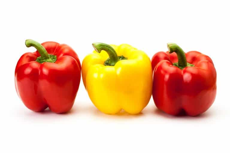 two red bell peppers with a yellow bell pepper in between