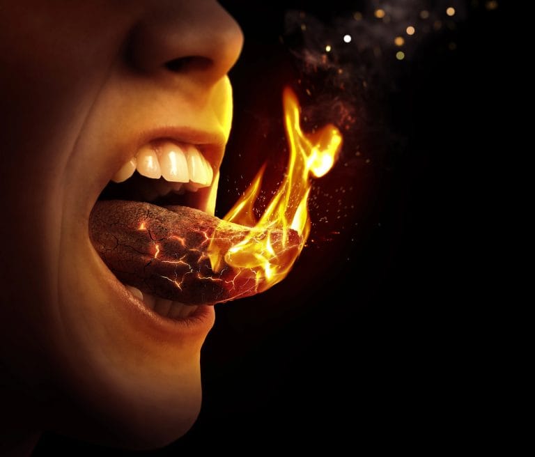 mouth with expression of pain sticking out tongue which is on fire.